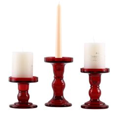 three red candles sitting next to each other