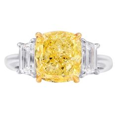 a fancy yellow diamond ring with three baguets