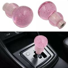 two pink knobs on the center console of a car, and an image of a steering wheel