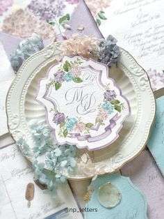 a plate with some flowers on it sitting on top of a table next to other papers