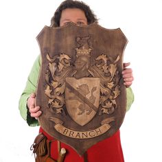 a person holding up a shield with the word branch on it