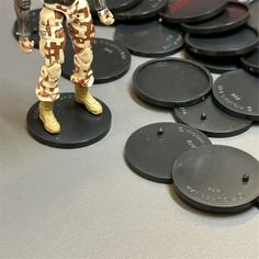 a close up of a toy soldier on a table with many other plastic discs in the background