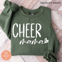 All of our Cheer Mama hoodies are handmade to order on an ultra soft crewneck that will quickly become your go to apparel item! You will never want to take it off! Our Mama sweatshirts are handmade to order with eco-friendly water based ink that feels good and lasts longer! ♥The details♥ This unisex sweatshirt is crafted from soft, breathable fabric for ultimate comfort. Printed with an eco-friendly water-based ink, this sweater not only looks great but also supports sustainable practices. The u Green Fleece Sweatshirt With Letter Print, Cute Green Sweatshirt With Letter Print, Cute Green Sweatshirt For Winter, Cute Green Winter Sweatshirt, Green Pre-shrunk Hoodie With Crew Neck, Green Pre-shrunk Crew Neck Hoodie, Green Casual Pre-shrunk Hoodie, Casual Green Pre-shrunk Hoodie, Green Long Sleeve Sweatshirt With Lettering