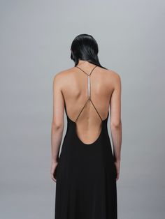 AN OPEN BACK DRESS, FEATURING A SCULPTURAL BIOMORPHIC SPINE METAL TRIM, ACCENTUATES THE BEAUTY OF THE HUMAN FORM. HIGH STRETCH AND COMFORT-FEEL JERSEY. MAXI LENGTH. STYLED WITH: BUTT BAG MESH HAND BAG HUMAN MESH BAG STRETCH JERSEY GRACE LING SIGNATURE LOGO ENGRAVED SHIPS IMMEDIATELY SHIPS WORLDWIDE Elegant Black Maxi Dress With Strappy Back, Black Low Back Maxi Dress For Evening, Black Low-back Maxi Dress For Evening, Black Backless Dress With Tie Back For Formal Occasions, Black Backless Formal Dress With Tie Back, Formal Black Backless Dress With Tie Back, Black Low Back Maxi Dress For Night Out, Black Backless Dress With Spaghetti Straps For Formal Events, Black Spaghetti Strap Backless Dress For Evening