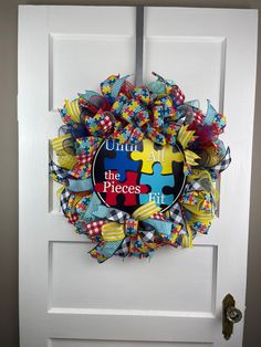 Autism Awareness door wreath, Autism wall decor, Autism door hanger, Until all the pieces fit, child or adult room decor with Blue, Red and Yellow puzzle pieces.  Hang this wreath on your front door, entryway, over your mantle, or maybe you need a gift for a birthday, anniversary, housewarming, wedding, or Christmas gift.  Measurements: 24" H x 24"  W x 7" D Please be sure to use a tape measure if you are unsure of how large or small the size of the wreath measures. Indoor/Outdoor use, but for l Adult Room Decor, Front Door Entryway, Door Entryway, Front Door Wreath, Red And Yellow, Door Wreath Hanger, Door Wreath, Tape Measure, Puzzle Pieces