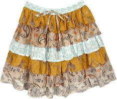 A cute floral cotton short skirt with six ruffled layers in beige and sky blue colors.  This cute bouncy bohemian short skirt is an ideal outfit choice for hot summer weather. #tlb #TieredSkirt #vacationclothing #beachwrap #Floral #Printed #bohemianfashion #ColorfulShortSkirt #BeachSkirt #RuffledSkirt Tiered Floral Print Beach Skirt, Tiered Summer Skirt For The Beach, Tiered Skirt For Summer Beach, Tiered Beach Skirt For Summer, Tiered Summer Beach Skirt, Multicolor Tiered Skirt With Ruffle Hem, Casual Tiered Mini Skirt For Beach, Casual Tiered Mini Skirt For The Beach, Summer Cotton Brown Skirt