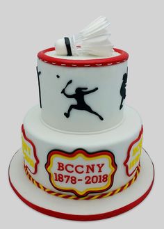 a cake decorated with an image of a man playing badminton on it's side