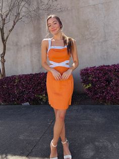 Step out in style with the Jacques Contrast Mini Dress in bold orange. With thick straps and a unique side cut out, this mini dress is perfect for any occasion. Featuring contrasting colors, this dress is sure to make a statement. Stand out from the crowd with this one-of-a-kind piece. Orange Cutout Summer Dress, Orange Printed Mini Dress, Orange Mini Dress With Vibrant Print, Orange Sleeveless Cotton Mini Dress, Orange Color Block V-neck Dress, Side Cuts, Mink Pink, Hello Gorgeous, Upcoming Events