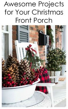 a white chair sitting on top of a porch covered in pine cones and red berries