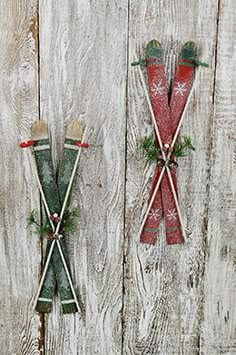 three christmas decorations hanging on the side of a wooden wall