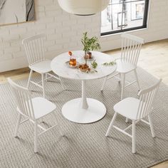 a white table with four chairs around it