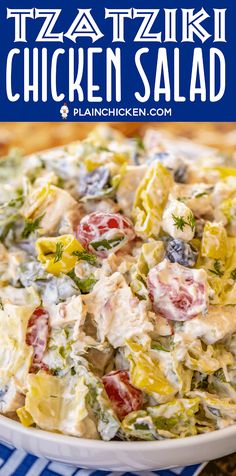 a white bowl filled with chicken salad on top of a blue and white table cloth