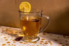 a glass mug filled with tea and lemon