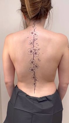 the back of a woman's body with flowers on her upper and lower back