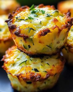 three mini quiche cups stacked on top of each other with cheese and herbs in the middle