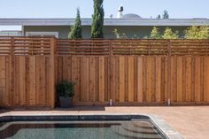 a hot tub sitting next to a wooden fence