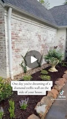 a brick house with landscaping in the front yard and one day you're dreaming of a diamond trellis wall on the side of your house