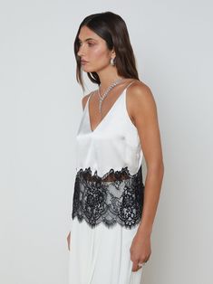 An artful mix of silk and lace makes our white and black Bryna cami intriguing to the eye and luxurious against the skin.• 100% silk charmeuse with floral lace inset• Deep V-neckline• Relaxed fit• Adjustable straps• Scalloped hem• No closures | L'AGENCE Bryna Silk Lace Camisole In White/Black White Lace Camisole With Contrast Lace, V-neck Lace Camisole With Contrast Lace, V-neck Satin Camisole With Lace Trim, White Lace Trim V-neck Camisole, Luxury Lace Top V-neck Camisole, Lace Camisole, Lace Inset, Scalloped Hem, Silk Charmeuse