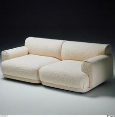 a white couch sitting on top of a gray floor