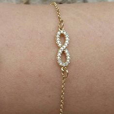 A nice infinity charm with Cubic Zirconia hanging on a gold-filled chain. It is elegant and dainty but still eye-catching. Ideal for bridesmaid gift or anniversary gift. This astonishing infinity charm is the perfect gift for every woman. A nice gift for her Length approx. 6.5 inches / 16.5 cm - can be adjusted upon request. ♥ All items will be delivered in a nice gift envelope to minimize shipping expenses for you! You may choose gift wrapping at checkout if you wish! If you need it sooner, sel Gold Cubic Zirconia Infinity Bracelet, Pearl Bar Necklace, Eternity Bracelet, Blue Gemstone Necklace, Dainty Pearl Necklace, Amulet Bracelet, Dainty Gold Jewelry, Single Pearl Necklace, Sister Bracelet