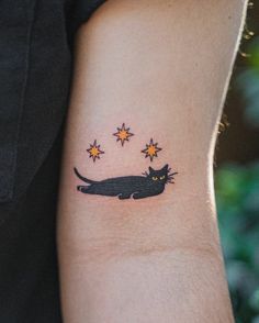 a black cat with stars on it's arm