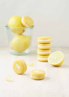 some lemons are sitting on the table and one is cut in half