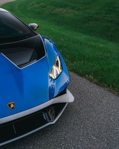 the front end of a blue sports car