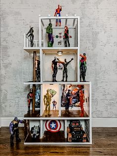 a book shelf filled with action figures and figurines on top of each other