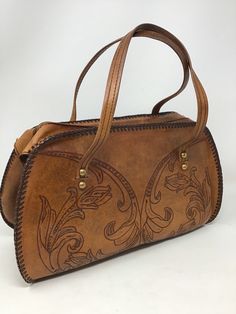 "Measures 13\" in length/ 9\" in height /4\"-7\"sides/strap drop 6\"/Good vintage condition /no issues /clean interior /smoke-free home (122)" Vintage Brown Hand-tooled Travel Shoulder Bag, Hand Tooled Vintage Brown Travel Shoulder Bag, Retro Hand-tooled Satchel Shoulder Bag, Vintage Hand Tooled Satchel For Daily Use, Retro Hand Tooled Satchel Shoulder Bag, Retro Hand Tooled Shoulder Bag For Daily Use, Retro Brown Hand Tooled Shoulder Bag, Vintage Brown Hand Tooled Bag, Brown Retro Shoulder Bag With Hand Tooled Details