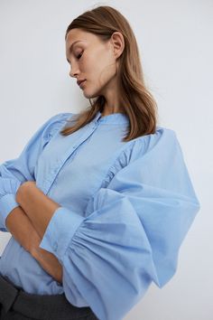 Loose-fit blouse in woven cotton fabric. Band collar  short button placket  and long  voluminous batwing sleeves with button at cuffs. Gathers on shoulders and visible seams at front and back. Gently curved hem. Oversized Blue Blouse With Batwing Sleeves, Spring Cotton T-shirt With Batwing Sleeves, H&m Spring Blouse With Button Closure, H&m Daywear Blouse With Button Closure, Oversized Blue Button-up Blouse, Active Swimwear, Sportswear Trends, H&m Shoes, Loose Fit Blouse