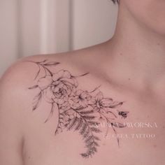 a woman's chest with flowers and leaves on it