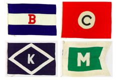 four different colored flags with the letters k, c, and m written in them