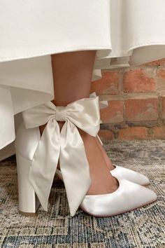 Simple, understated, stunning. The Arabella bow heel from Perfect Bridal Company is perfect for the modern bride looking for maximum impact without being over designed or fussy. Based on a stunning silhouette incorporating a high block heel and the perfect pointed toe, it is the oversized ivory satin bow which adds the perfect statement to an otherwise minimalist inspired shoe.

Available from Lily Francis Bridal. Wedding Shoes Wide Heel, Block Heels Bridal, Cute Block Heels, Wedding Heels Block Heel, Bride Comfortable Shoes, Bridal Reception Shoes, Wedding Heels Bow, Cool Wedding Shoes, Winter Wedding Heels