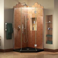 a bathroom with a walk in shower next to a shelf filled with towels and other items