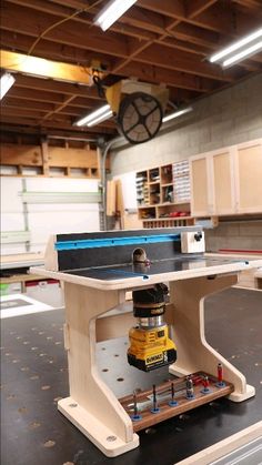 a workbench with a driller on it in the middle of a garage