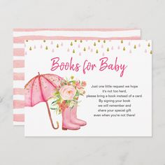 a baby shower card with pink boots and flowers holding an umbrella on it's side