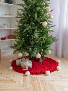 a small christmas tree with presents under it