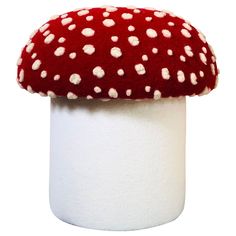 a red mushroom sitting on top of a white pillar