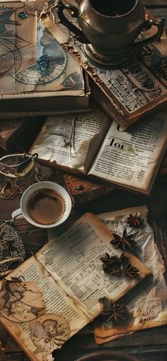 an old book and cup of coffee sit on a table next to some other books