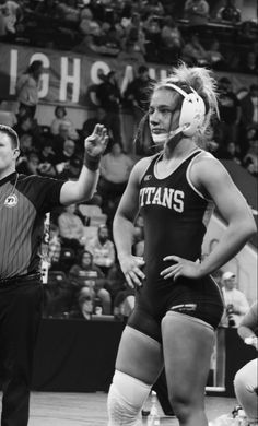 two women in wrestling uniforms standing next to each other