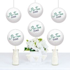 four golf balls with the words par - fee time on them and flowers in vases