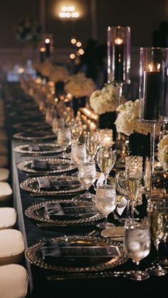 a long table is set up with silverware and candles for an elegant dinner party