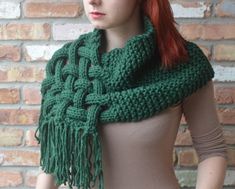 a woman wearing a green knitted scarf