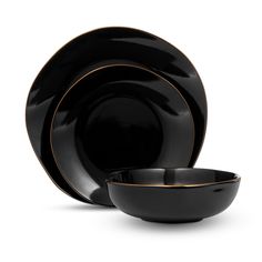 black dinnerware set with gold trimmings on the rim and side plates,