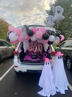 the trunk of a car decorated with balloons and decorations for a 30th birthday party in a parking lot