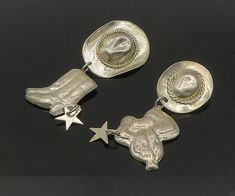 "MEXICO 925 Silver - Vintage Cowboy Hat Saddle & Star Dangle Earrings - EG10516  Jewelry Type:         Earrings   Metal Type:            925 Silver  Metal Size:             2.75\"  Stone Type:            N/A  Condition:              N/A  Jewelry Weight:     19.3 Grams  PLEASE NOTE: THIS ITEM IS PRE-OWNED. ALTHOUGH MOST ITEMS ARE IN VERY GOOD CONDITION, SOME MAY NEED CLEANING AND/OR MINOR REPAIRS. WE MAKE A VERY STRONG EFFORT TO UPLOAD CLEAR PICTURES. PLEASE INSPECT ALL PICTURES AND ASK ALL QUESTIONS YOU MAY HAVE PRIOR TO MAKING A PURCHASE. NOT ALL STONES ARE GENUINE, SOME ARE ENHANCED OR CREATED." Vintage Silver Jewelry For Rodeo, Vintage Cowboy Hat, Vintage Star-shaped Metal Jewelry, Adjustable Star-shaped Sterling Silver Earrings, Nickel-free Adjustable Southwestern Earrings, Star Dangle Earrings, Southwestern Style Nickel-free Brown Earrings, Clear Pictures, Chapeau Cowboy