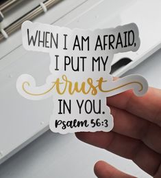 someone holding up a sticker that says, when i am afraid, i put my trust in you