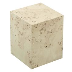 a white marble block sitting on top of a white floor