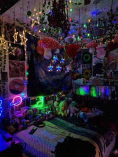 a bed room with lots of stuffed animals and lights hanging from the ceiling above it