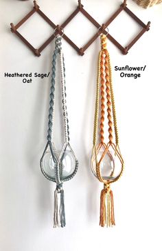 three different colors of macrame hanging from a hook on a wall with hooks attached to it